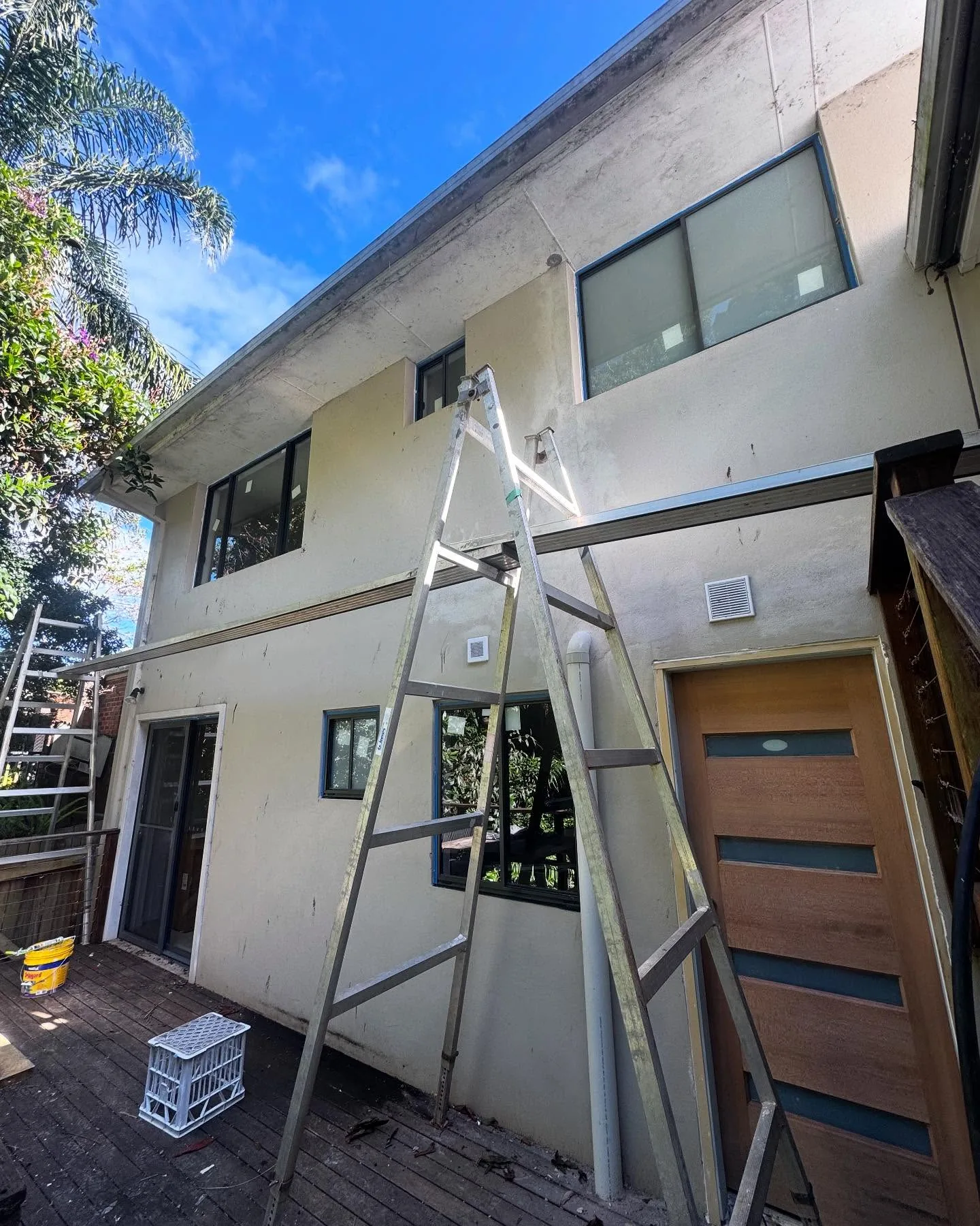Weathered, stained render exterior before recoating